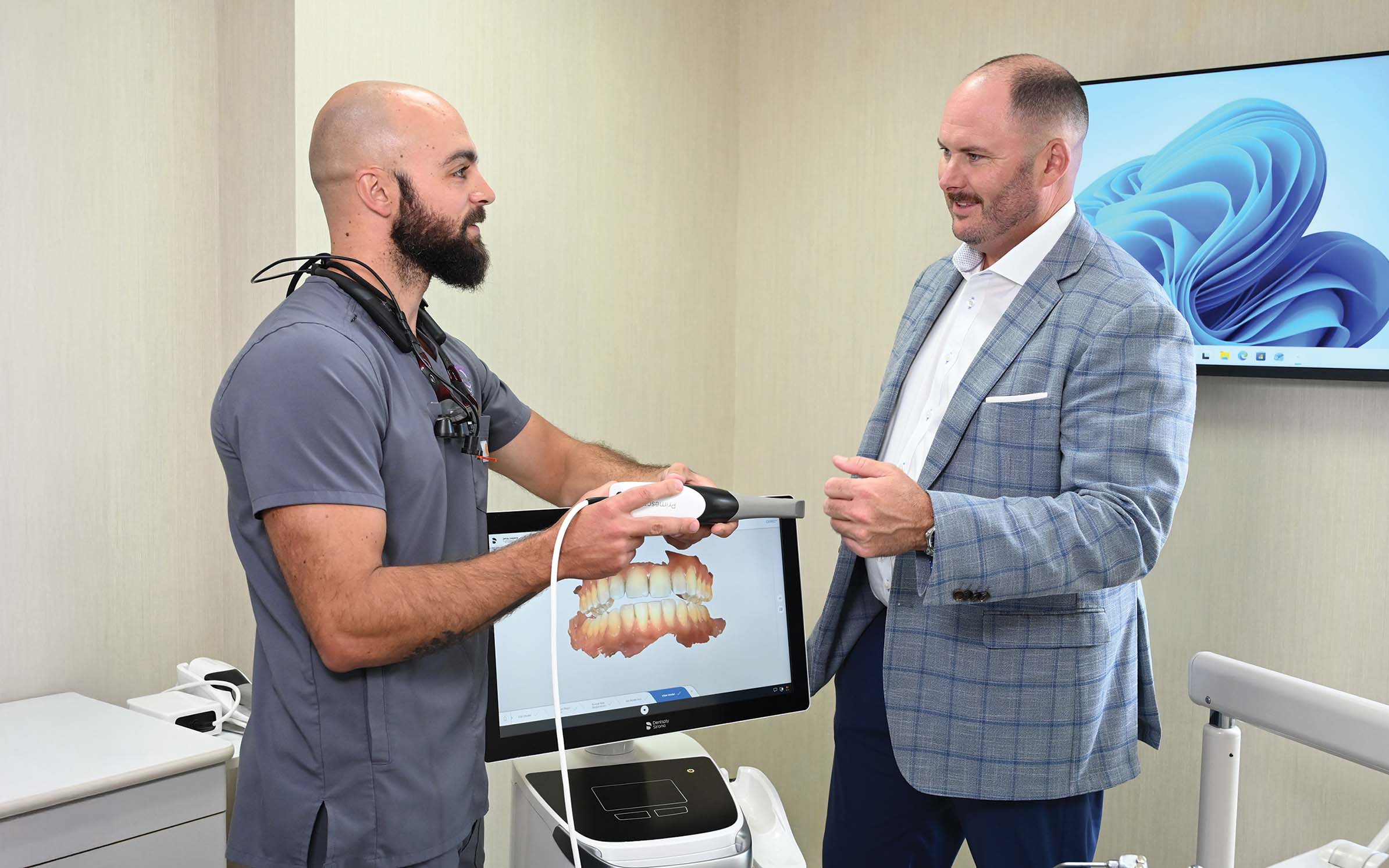 David Cushman of Genesee Regional Bank (right) meets with client Dr. Frank L. Sapere of Webster Dental Group. | Photo: John Smillie