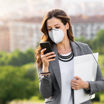 woman in a mask looking at phone