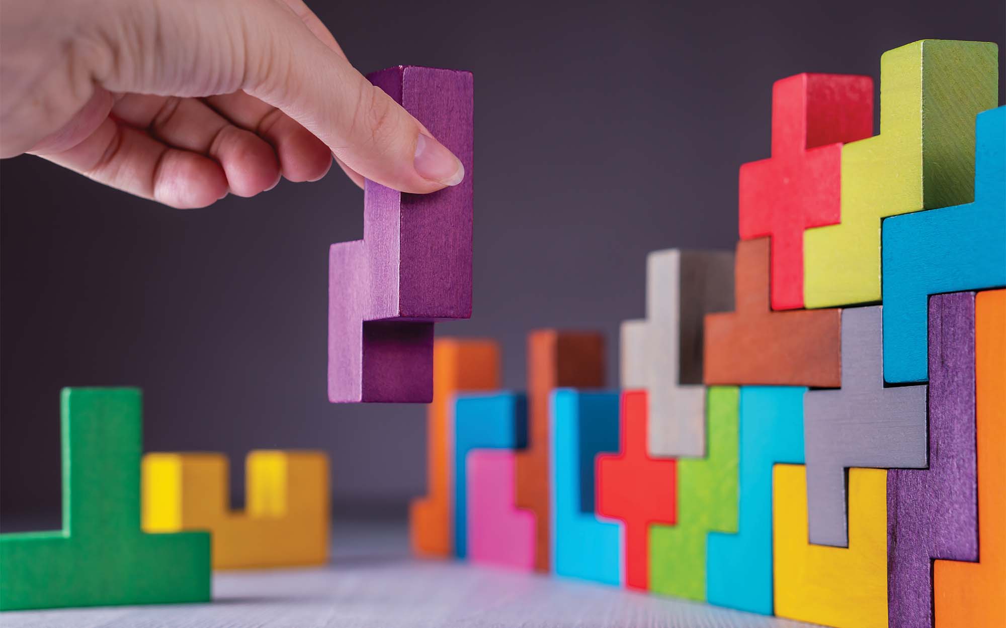 Hand stacking colored blocks