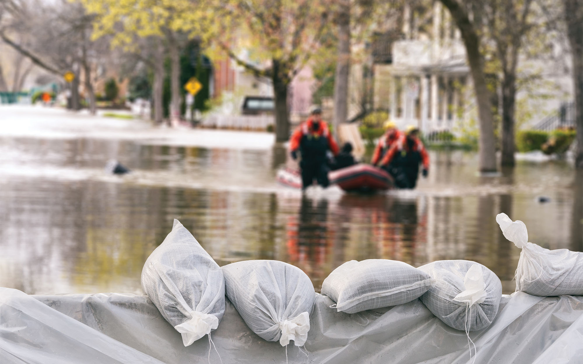 people walking down flooded street