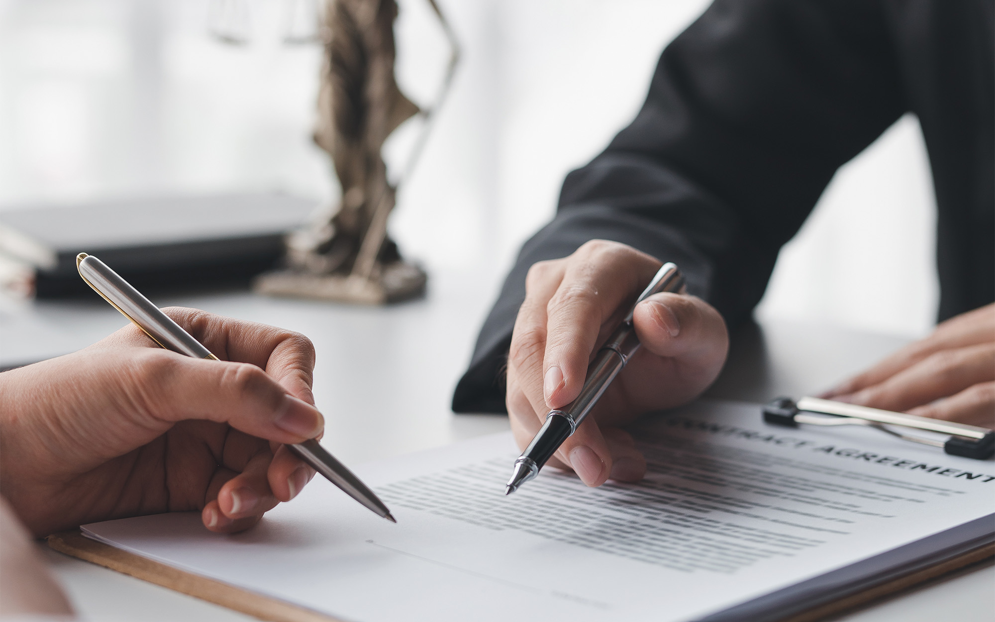 Hands poised over paperwork