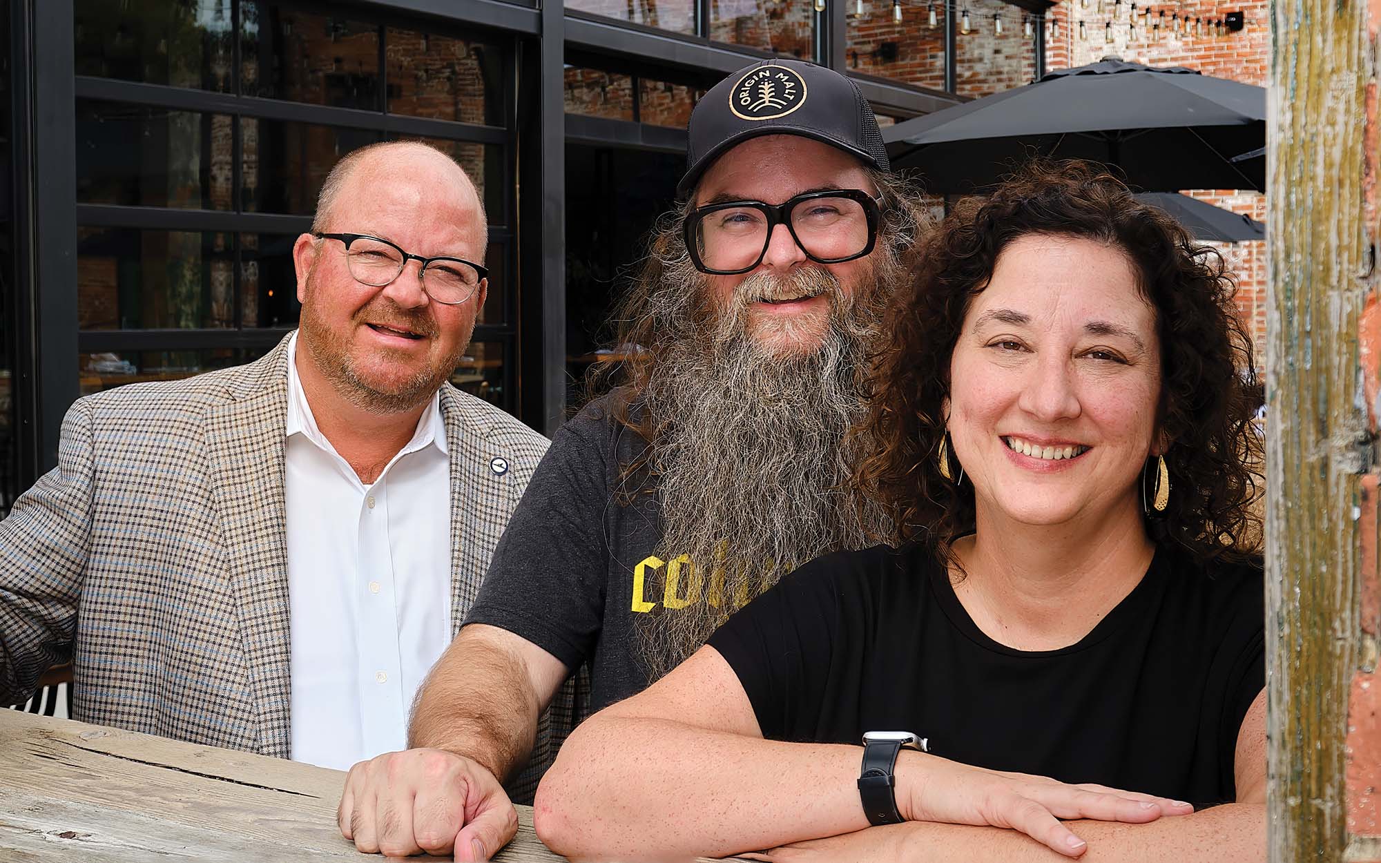 Heartland Bank chairman, president and CEO Scott McComb with clients Eric and Beth Bean, co-owners of Columbus Brewing Company
