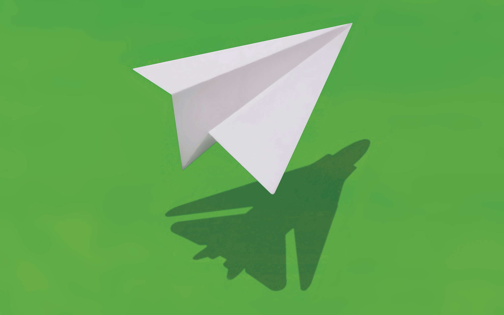 paper airplane on green background